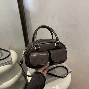 Retro deep brown large capacity top handle bag with dual front pockets and shoulder strap