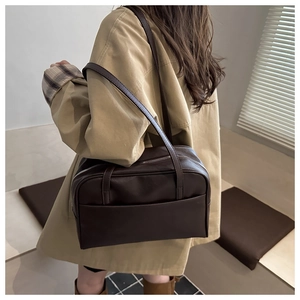 Brown PU leather shoulder bag shown in street style scene with chic autumn outfit