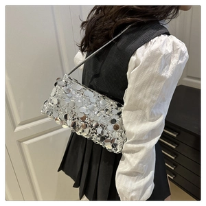 Detailed view of silver sequin shoulder bag on model for elegant party evening wear
