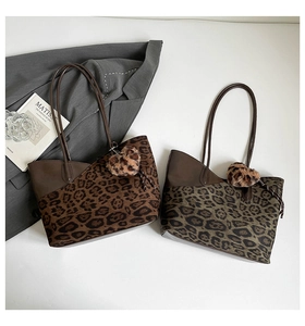 Close-up of leopard print tote bags with fuzzy charms and stylish leather patchwork