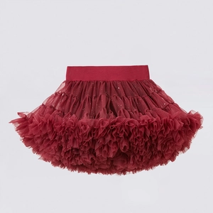 Detail of red tiered tutu skirt featuring silver sequins and elastic waistband for girls