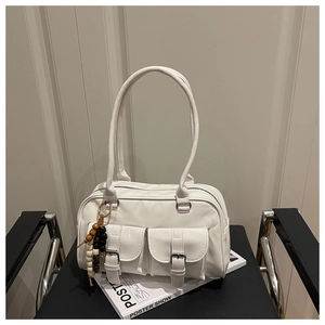 Close-up of white patent leather shoulder bag with vintage wooden beads and buckles