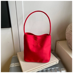 Detail of red fabric tote bag with Hope and future embroidery and sleek single handle