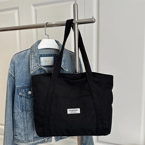 Large black corduroy tote bag with Fashion Instinct patch for daily commute and school