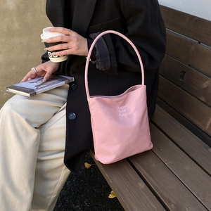 Pink nylon bucket bag with Hope and Future embroidery and long shoulder straps
