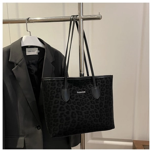Detail view of large leopard print tote bag with plush texture and FASHION lettering