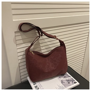 Detail of burgundy leopard print tote bag featuring adjustable strap and gold metal zipper
