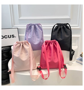 Waterproof nylon drawstring backpacks in four colors including pink, purple, and black