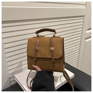 Detail of vintage brown suede backpack with leather straps and bear embossed patterns