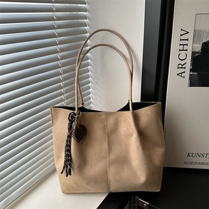 Minimalist beige suede tote bag with woven pendant and large capacity for commuting