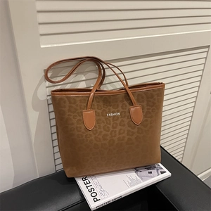 Large dark brown leopard print tote bag with white FASHION text and long slim handles