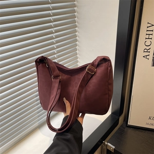Minimalist large burgundy tote bag with adjustable shoulder strap and metal hardware