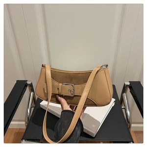 Close-up of khaki shoulder bag with faux leather, suede texture, and buckle detail