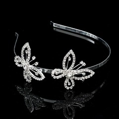 Close-up of silver bridal headband featuring intricate rhinestone hollow butterfly details