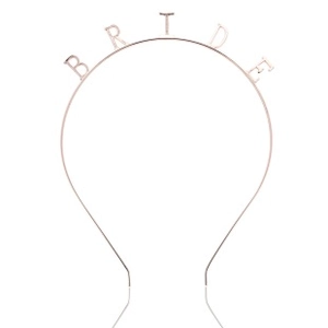 Close-up of rose gold alloy headband with Bride lettering and polished reflective finish