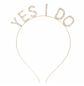 Detail shot of a golden metal headband with sparkling rhinestone YES I DO lettering