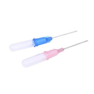 Close-up of industrial metal dispensing needles with blue and pink color-coded hubs