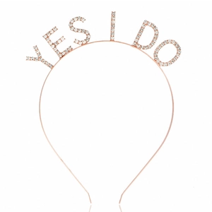 Macro detail of rose gold headband with rhinestone YES I DO lettering for bridal party