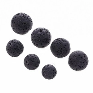 Detailed close-up of black porous lava stone beads for aromatherapy jewelry making