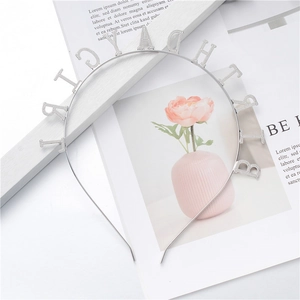 Detail of silver Happy Birthday headband with textured glitter finish and metal luster