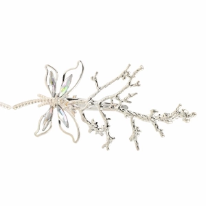 Macro view of vintage dragonfly hair clip with silver metal and iridescent crystal wings