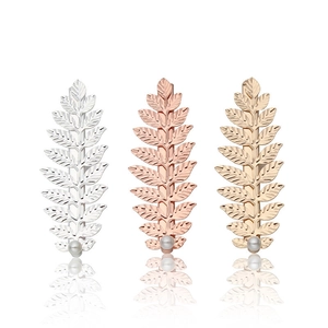 Three-piece leaf hair clip set with grey pearls in silver, gold, and rose gold finishes