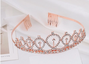 Close-up of rose gold rhinestone tiara with water drop design and side combs for secure fit