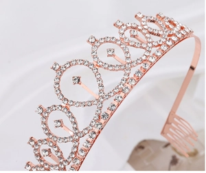 Detailed macro view of rose gold bridal crown featuring teardrop rhinestones and secure combs