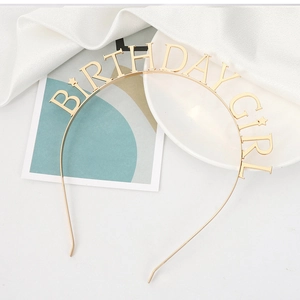 Close-up of golden metal headband featuring Birthday Girl lettering and star details