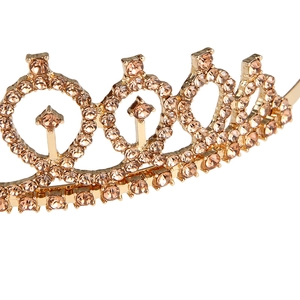 Detailed close-up of champagne crystal tiara with intricate diamond-shaped gold alloy frame