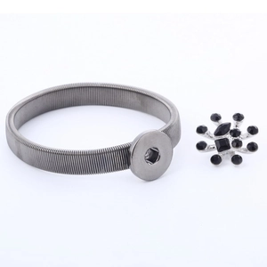 Detail of silver elastic arm band with detachable black gemstone floral snap button