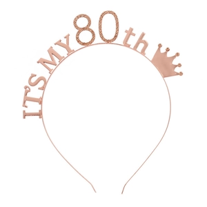 Close-up of rose gold 80th birthday headband with rhinestones and crown detail