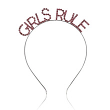 Detail of silver headband featuring purple rhinestone Girls Rule lettering for parties