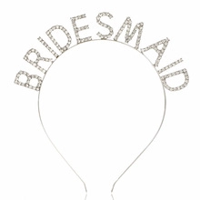 Detailed view of silver bridesmaid headband featuring rhinestone lettering and metal frame