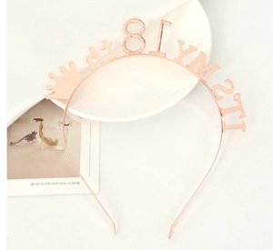 Close-up of rose gold 18th birthday tiara headband with glittery 'IT'S MY' lettering