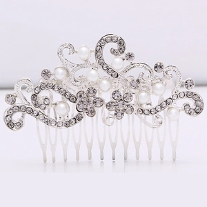Close-up of bridal hair comb with pearls and rhinestones on a 10-tooth silver alloy base