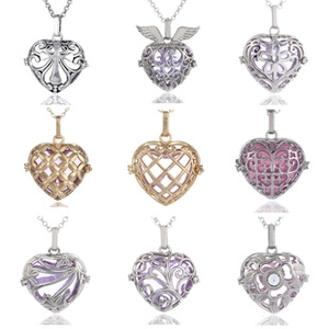 Detailed grid of hollow heart pendants with ornate floral and angel wing engravings