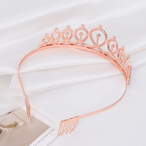 Elegant rose gold rhinestone bridal crown with hair combs on white silk background