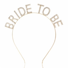 Detailed view of gold metal headband featuring sparkling rhinestone BRIDE TO BE lettering