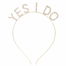 Detailed view of the gold headband featuring a crystal-studded 'YES I DO' letter design