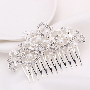 Close-up of elegant silver hair comb with crystal leaves and white pearls decoration