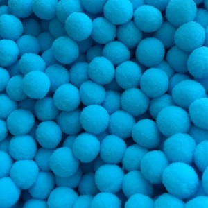 Pile of sky blue 16mm cotton pompoms for perfume diffuser necklaces and jewelry DIY