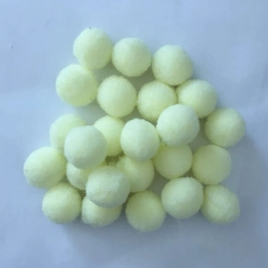 Close-up of fluffy pale yellow 16mm cotton balls for perfume diffuser pendants