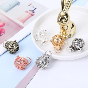 Hollow spherical filigree pendant necklace in silver, gold, and bronze finishes