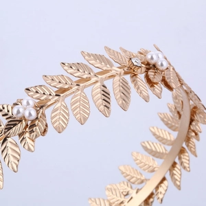 Golden bridal laurel leaf headband featuring delicate pearls and rhinestone details