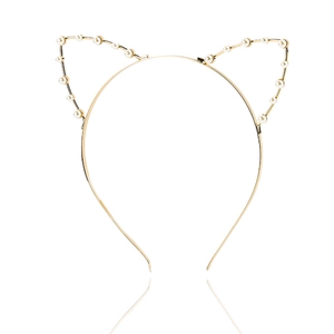 Detail of a golden metal cat ear headband with white imitation pearls on a white background