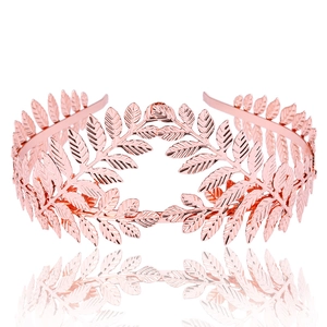 Macro detail of rose gold leaf tiara showing intricate metallic textures and reflections