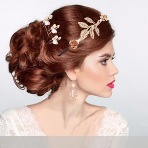 Golden bridal headband set with pearl leaves and roses shown on an elegant model