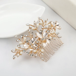 Detailed view of bridal hair comb with gold leaves, white pearls and crystal rhinestones