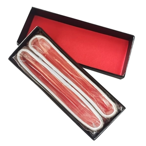 Rectangular black gift box with red lining holding silver metal spring coils